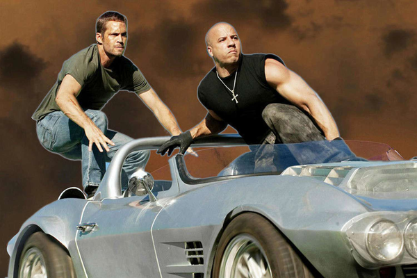 Paul Walker and Vin Diesel riding a car like a tandem skateboard in "Fast Five" (2011)